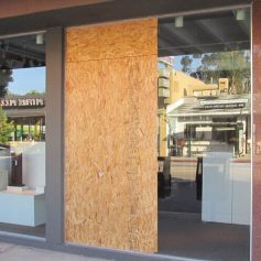 Boarded storefront glass opening